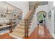 Grand staircase with wrought iron spindles and hardwood floors leading to the second level at 6430 Stirling Ln, Indian Land, SC 29707