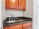 Stylish wet bar with a dark countertop and wood cabinetry at 6430 Stirling Ln, Indian Land, SC 29707