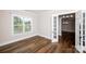 Comfortable bedroom with hardwood floors and ample natural light, featuring a view into the dining room at 720 Cavesson Way, Monroe, NC 28110