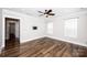 Bright bedroom with hardwood floors, ceiling fan, and two windows offering natural light at 720 Cavesson Way, Monroe, NC 28110