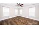 Bright bedroom with hardwood floors, ceiling fan, and ample natural light at 720 Cavesson Way, Monroe, NC 28110
