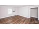 Expansive bonus room with hardwood flooring, neutral walls, and large window providing ample light at 720 Cavesson Way, Monroe, NC 28110