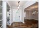 Inviting foyer with hardwood floors, a stylish pendant light, and glass-paneled doors, creating a bright entrance at 720 Cavesson Way, Monroe, NC 28110