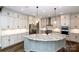Bright kitchen boasts an island, stainless appliances, ample counter space and modern fixtures at 720 Cavesson Way, Monroe, NC 28110