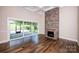 Spacious living room featuring a stone fireplace, hardwood floors, and sliding doors to a covered patio at 720 Cavesson Way, Monroe, NC 28110