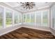 Sun room with a ceiling fan and plenty of windows overlooking the backyard at 720 Cavesson Way, Monroe, NC 28110