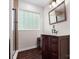Bathroom featuring a classic vanity and decorative mirror next to a modern walk-in shower at 730 Cove Rd, Gastonia, NC 28052