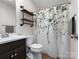 A well lit bathroom with modern fixtures and a leafy shower curtain at 730 Cove Rd, Gastonia, NC 28052