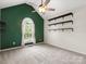 A bright bedroom with vaulted ceilings and dark wood shelving at 730 Cove Rd, Gastonia, NC 28052