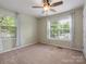 A well lit bedroom featuring two windows and a ceiling fan at 730 Cove Rd, Gastonia, NC 28052