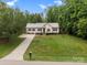 Charming home featuring a well-manicured lawn and a long driveway leading to the house at 730 Cove Rd, Gastonia, NC 28052