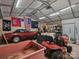 A spacious garage houses a classic car, lawnmower, and ample storage space at 730 Cove Rd, Gastonia, NC 28052