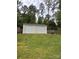 Two car detached garage sitting in the backyard with a fresh coat of paint and rolling metal doors at 730 Cove Rd, Gastonia, NC 28052