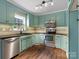 A kitchen featuring stainless steel appliances and hardwood floors at 730 Cove Rd, Gastonia, NC 28052