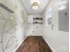 Clean laundry room with wood floors, painted murals, shelving and a light fixture at 730 Cove Rd, Gastonia, NC 28052