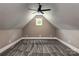 Attic features neutral paint, gray carpeting, white trim, ceiling fan and bright window at 7703 Juniper Ln, Denver, NC 28037