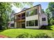Back exterior featuring upper and lower wooden decks and large windows overlooking the yard at 7703 Juniper Ln, Denver, NC 28037