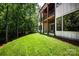 View of the wooden deck and lower patio of the back exterior and large grassy yard at 7703 Juniper Ln, Denver, NC 28037