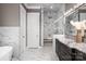 Luxury bathroom with marble floors and walls, a soaking tub, and a glass-enclosed shower with dual shower heads at 7703 Juniper Ln, Denver, NC 28037