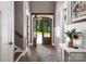 Warm and inviting foyer with hardwood floors and glass paneled wooden front door at 7703 Juniper Ln, Denver, NC 28037