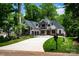 Beautiful two-story home featuring stone accents, modern garage doors, and a well-manicured lawn at 7703 Juniper Ln, Denver, NC 28037
