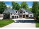 Lovely home with a three car garage, beautiful stonework, and a well-kept lawn at 7703 Juniper Ln, Denver, NC 28037