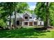 Charming front exterior featuring manicured lawn and detailed stonework, welcoming visitors to the home at 7703 Juniper Ln, Denver, NC 28037