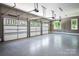 Spacious three-car garage with epoxy flooring and ample storage space at 7703 Juniper Ln, Denver, NC 28037