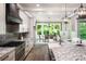 Well-equipped kitchen featuring granite countertops, island seating, and natural light at 7703 Juniper Ln, Denver, NC 28037