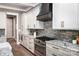 Modern kitchen featuring custom cabinets, a stainless steel range, and a granite countertop at 7703 Juniper Ln, Denver, NC 28037