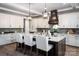 Elegant kitchen with island seating, granite countertops, and stainless steel appliances at 7703 Juniper Ln, Denver, NC 28037