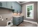 Functional laundry room with granite countertops, custom cabinets, and a window at 7703 Juniper Ln, Denver, NC 28037