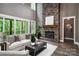 Relaxing living room featuring a stone fireplace and access to an outdoor balcony at 7703 Juniper Ln, Denver, NC 28037