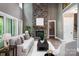 Spacious living room with a stone fireplace and sliding doors to the outdoor space at 7703 Juniper Ln, Denver, NC 28037