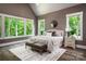 Comfortable primary bedroom with large windows offering beautiful wooded views at 7703 Juniper Ln, Denver, NC 28037