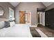 Beautiful main bedroom with en suite bathroom with a wood-accented sliding door and modern decor at 7703 Juniper Ln, Denver, NC 28037