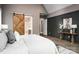 Stylish main bedroom featuring wood accents, a sliding door to the bathroom, and decoratively painted walls at 7703 Juniper Ln, Denver, NC 28037