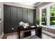 Office space featuring dark paneled walls, modern desk, and large window at 7703 Juniper Ln, Denver, NC 28037