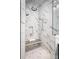 Stunning shower showcasing dual shower heads, marble tile, a built-in bench, and glass door enclosure at 7703 Juniper Ln, Denver, NC 28037