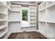 Spacious walk-in closet with custom shelves and a large window providing natural light at 7703 Juniper Ln, Denver, NC 28037