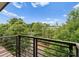 Scenic view from the balcony overlooking lush greenery and a quiet street, offering a serene and picturesque outdoor space at 859 Academy St, Charlotte, NC 28205