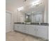 A modern bathroom with double sinks and granite counters adds elegance to the home at 859 Academy St, Charlotte, NC 28205