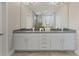 A bathroom with double sinks, granite counters, and white cabinets adds elegance at 859 Academy St, Charlotte, NC 28205