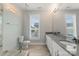 Modern bathroom featuring dual sinks, granite counters, and a separate shower at 859 Academy St, Charlotte, NC 28205