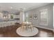 Bright dining area with a round table, stylish chairs, and natural light, complemented by a modern kitchen with stainless steel appliances at 859 Academy St, Charlotte, NC 28205