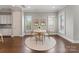 Inviting dining area with wood flooring, a modern table, and bright windows with plantation shutters at 859 Academy St, Charlotte, NC 28205