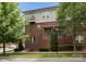 Charming brick townhome featuring multiple stories, a cozy balcony, and professionally landscaped front yard at 859 Academy St, Charlotte, NC 28205