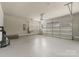 A two-car garage with an epoxy floor, windows and an electric garage door opener at 859 Academy St, Charlotte, NC 28205
