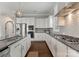 Well-equipped kitchen with stainless steel appliances, granite countertops and dark wood floors at 859 Academy St, Charlotte, NC 28205