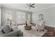 Bright living room with a comfortable sofa, patterned chairs, and a ceiling fan, showcasing a cozy and stylish space at 859 Academy St, Charlotte, NC 28205
